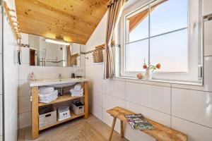 a bathroom with a sink and a window at Ferienhaus Geyerbad mit Sauna in Meßstetten +36 photos