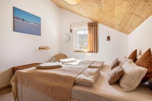 a bedroom with a large bed with a wooden ceiling at Ferienhaus Geyerbad mit Sauna in Meßstetten