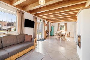 a living room with a couch and a table at Ferienhaus Geyerbad mit Sauna in Meßstetten