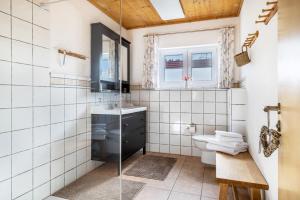 a bathroom with a sink and a toilet at Ferienhaus Eichenstein in Meßstetten +21 photos