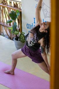 a woman doing a handstand on a yoga mat at Wake N Flow, Arugam Bay in Arugam Bay