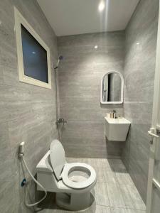 a bathroom with a toilet and a sink at Modren AD 23 in Dammam +15 photos