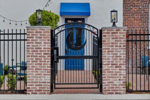 a black iron gate with a blue door in front of a building at The Ray Soulful King Studio Pool in Jacksonville