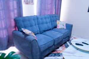 a blue couch sitting in a living room at Benson waweru APPARTMENT in Kakamega +1 photo