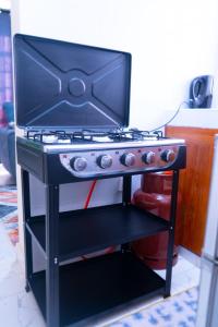 a stove top oven sitting on top of a shelf at Benson waweru APPARTMENT in Kakamega