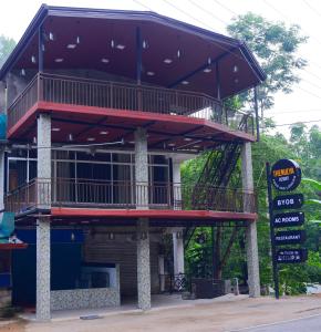 a building with a balcony on top of it at Thenulya Resort in Ella