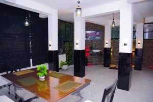 a dining room with a wooden table and chairs at Thenulya Resort in Ella +31 photos