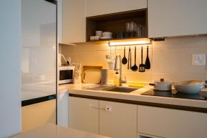 a kitchen with a sink and a counter with utensils at 가치스테이 강서 in Seoul