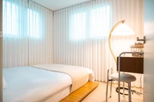 a bedroom with a bed and a desk and a chair at 가치스테이 강서 in Seoul +10 photos