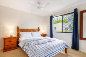 a bedroom with a bed and a window at 'Flinders' in Yeppoon
