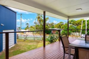 a balcony with a table and chairs on a deck at 'Flinders' in Yeppoon