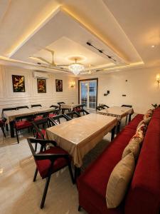 a large dining room with tables and chairs at Hotel Sunshine in Surajpur Jikkla