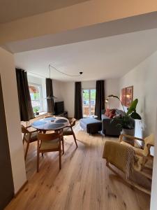 a living room with a table and a couch at Alpensegler in Mittenwald +15 photos