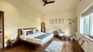 a bedroom with a bed and a ceiling fan at SaffronStays Oslo in Anjuna +30 photos