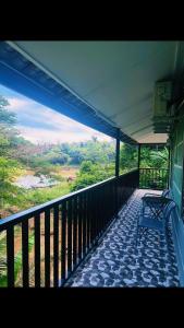 a blue bench sitting on a balcony of a building at Rainbow River View in Jerantut