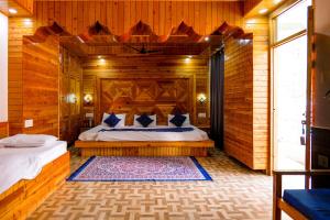 a bedroom with a bed in a wooden cabin at The Royal Pinewood in Kasol