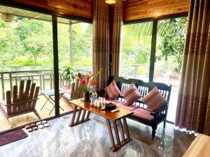 a living room with a couch and a table at Peaceful Garden Tam Cốc in Ninh Binh