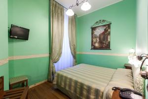 Postel nebo postele na pokoji v ubytování Hotel Belle Epoque