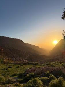 a view of the sun setting in the mountains at Dana panorama-green camp in Dana +22 photos