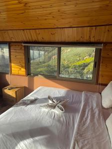 a bedroom with a bed with a bow on it at Dana panorama-green camp in Dana
