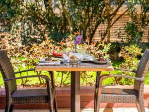 a table with a bowl of food on it with two chairs at Ibis Gaziantep in Gaziantep +82 photos