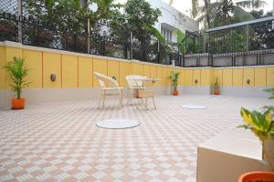 a patio with a table and chairs on a tiled floor at Studio 61 Saltlake Sector 1 Kolkata in kolkata