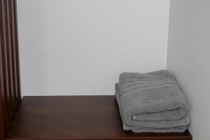 a towel sitting on a bed in a room at San Cristóbal Surf House lll in Puerto Baquerizo Moreno +32 photos