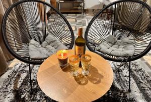 a table with a bottle of wine and two glasses at Vikendica Golubicanka in Bihać