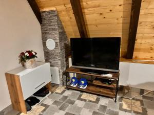 a living room with a flat screen tv on a stand at Vikendica Golubicanka in Bihać