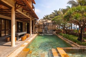 a swimming pool in the middle of a house at Sun Village Beach Resort in Tuy Hoa