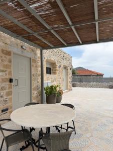 an outdoor patio with a table and chairs at Almyra Suites in Khalíkia