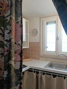 a kitchen with a sink and a window at Liberty 21 in Andria