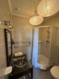 a bathroom with a sink and a shower and a toilet at Spicīte in Ventspils