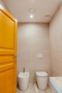 a bathroom with a toilet and a sink at DOMO MARE E TERRA Boutique Rooms and Spa in Posada