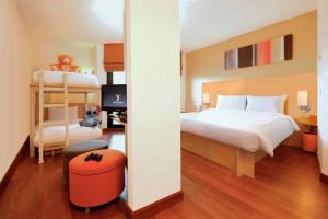 a bedroom with a bed and a desk and a bunk bed at Ibis Hua Hin in Hua Hin