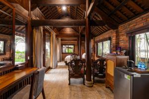 a living room with wooden walls and a wooden ceiling at Sun Village Beach Resort in Tuy Hoa