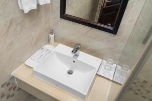 a bathroom with a white sink and a mirror at Binh Anh Hotel in Hanoi +66 photos