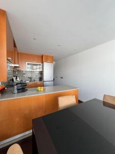 a kitchen with a table and a counter top at Beach House - Aguda Beach - 2 bedrooms in Arcozelo
