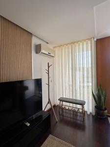a living room with a flat screen tv and a couch at Beach House - Aguda Beach - 2 bedrooms in Arcozelo