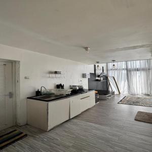 a kitchen with a sink and a counter top at Cabin Athenea Sikapuk in Kejajar +15 photos