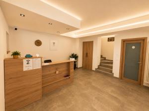 an office with a reception desk and a staircase at Sweet Alps in Tirano