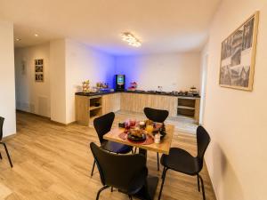 a dining room and kitchen with a table and chairs at Sweet Alps in Tirano