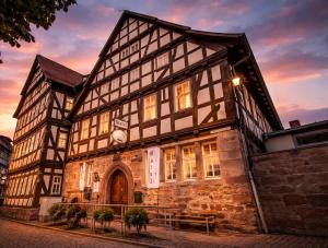an old building with a clock on it at Hotel & Café Schachtenburg in Schlitz