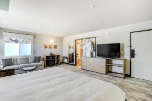 a bedroom with a large bed and a living room at The Outrider Hotel in Manitou Springs