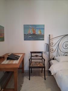 a bedroom with a desk and a chair and a bed at Maria Apostolou villa in Almiros