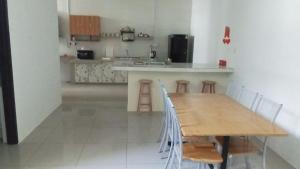 a kitchen with a wooden table and some chairs at Pusing Classic Semi D House in Pusing