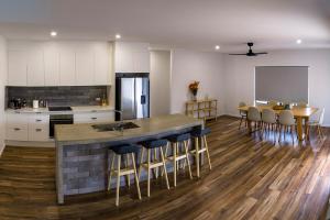 a kitchen and dining room with a island in the middle at The Village HQ in Yungaburra