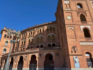 a large brick building with a clock tower at Ibis Madrid Centro las Ventas in Madrid +82 photos