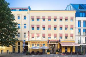 a large building with tables and chairs in front of it at Hotel Kastanienhof in Berlin