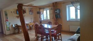 a dining room with a table and chairs at Agroturystyka pod Chyrową in Chyrowa
